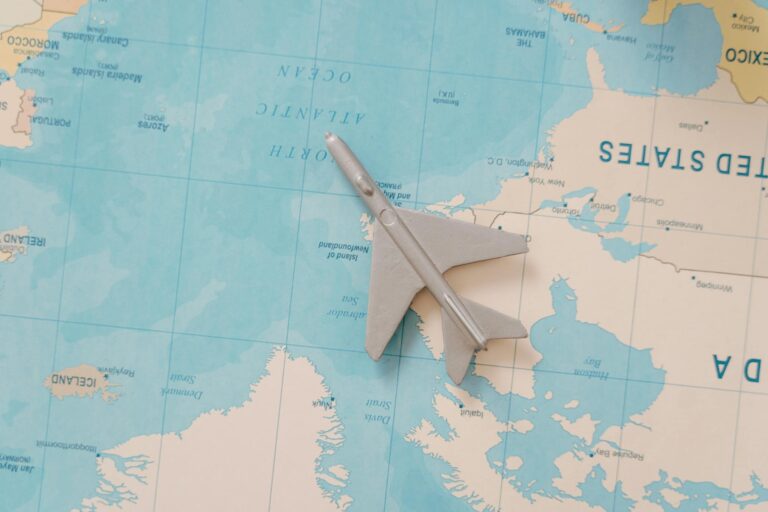 A toy airplane resting on a map, symbolizing travel and adventure planning.